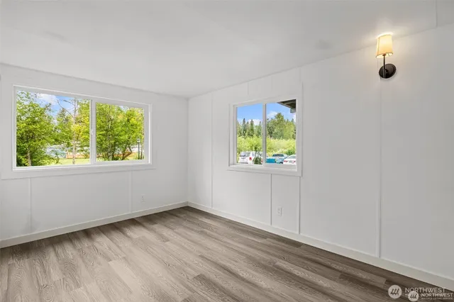 wooden floor in an empty room with a window