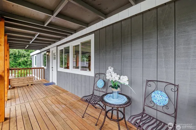 a dining room with furniture a chandelier and wooden floor