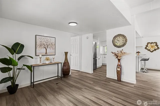 a living room with furniture a window and wooden floor