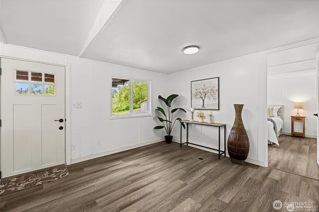 a view of a livingroom with furniture and hardwood floor