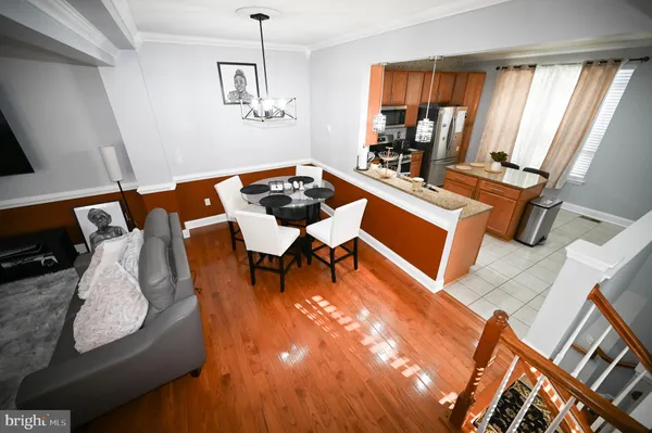 a kitchen with stainless steel appliances granite countertop a stove top oven a sink dishwasher and a refrigerator