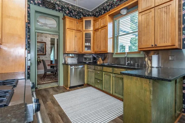 a kitchen that has a sink and a wooden floor