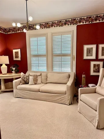 a living room with furniture windows and a chandelier