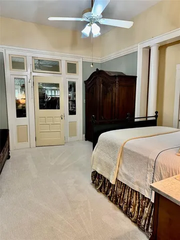 a bed room with a bed mirror and a window