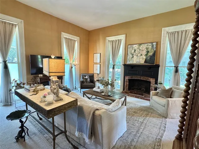 a living room with furniture and a fireplace