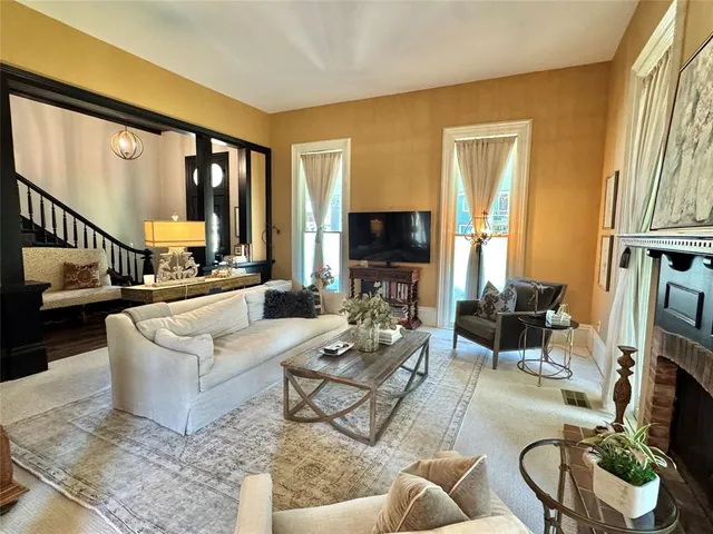a living room with furniture fireplace and a flat screen tv