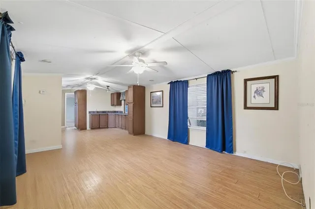 a view of a livingroom with furniture and a ceiling fan