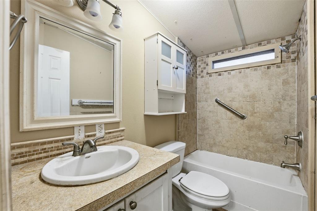 2220 Ellie Road, Unit A Auburndale, FL 33823 - Photo 18 of 41 a bathroom with a sink toilet tub and shower