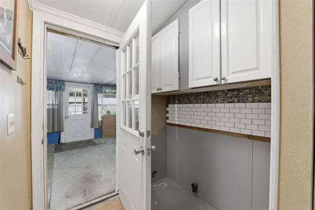 a view of a room with large windows and furniture