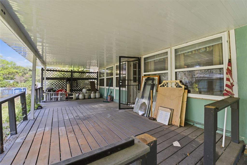 2220 Ellie Road, Unit A Auburndale, FL 33823 - Photo 23 of 41 a view of a deck with wooden floor and seating space