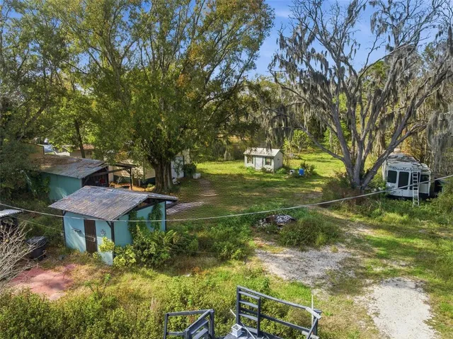 an aerial view of a house with a yard