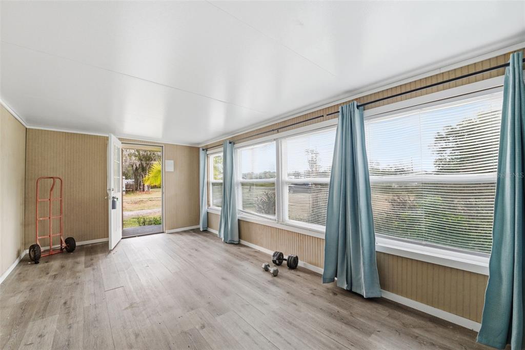 2220 Ellie Road, Unit A Auburndale, FL 33823 - Photo 10 of 41 a view of an empty room with a window and wooden floor