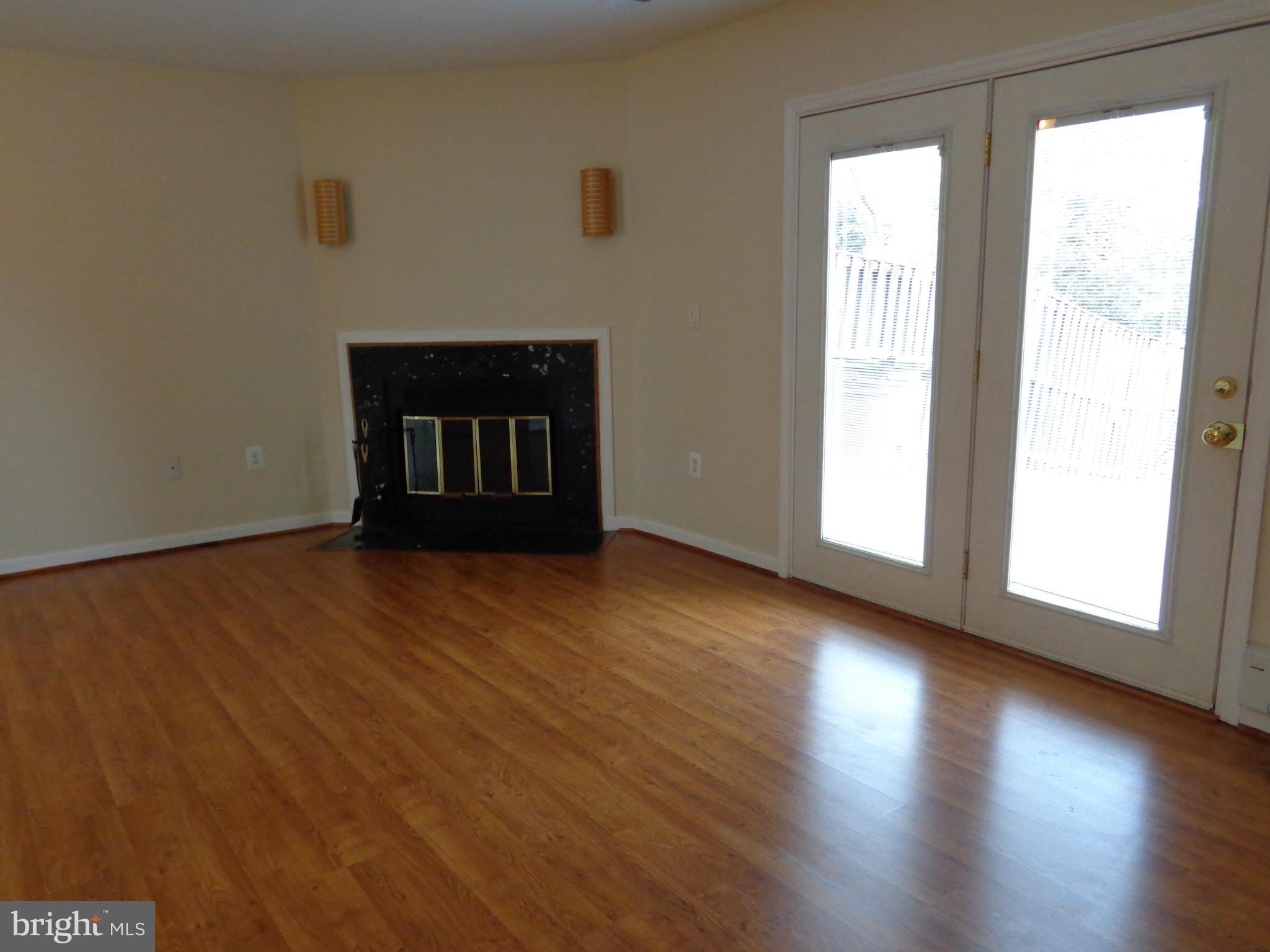 7782 Gateshead Lane Manassas, VA 20109 - Photo 2 of 17 a view of an empty room with wooden floor and a window