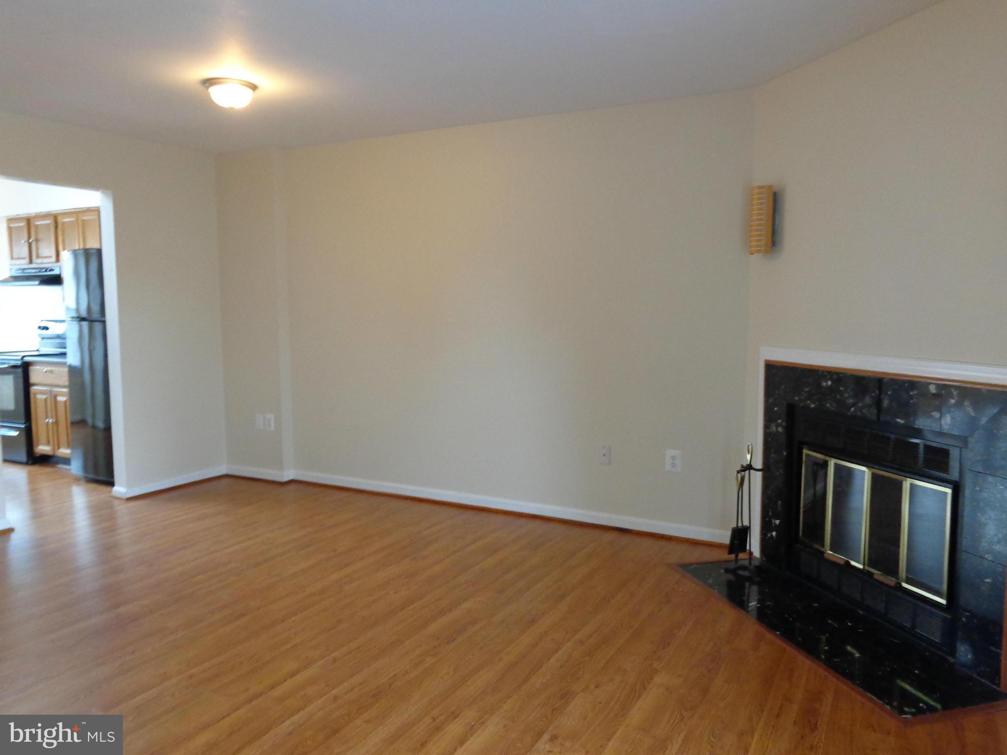 7782 Gateshead Lane Manassas, VA 20109 - Photo 3 of 17 a view of an empty room with wooden floor and a fireplace