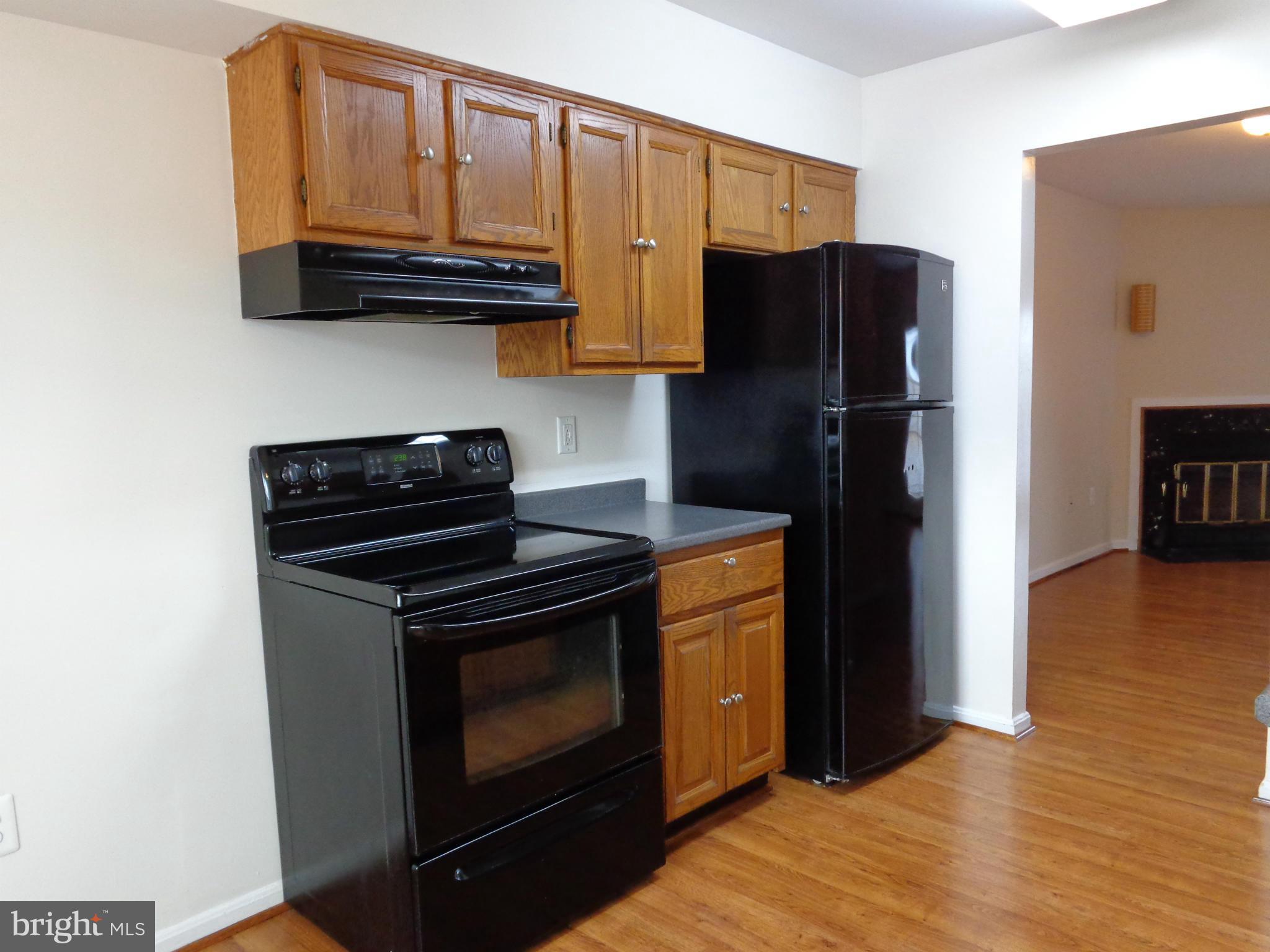 7782 Gateshead Lane Manassas, VA 20109 - Photo 5 of 17 a kitchen with stainless steel appliances granite countertop a refrigerator stove and microwave