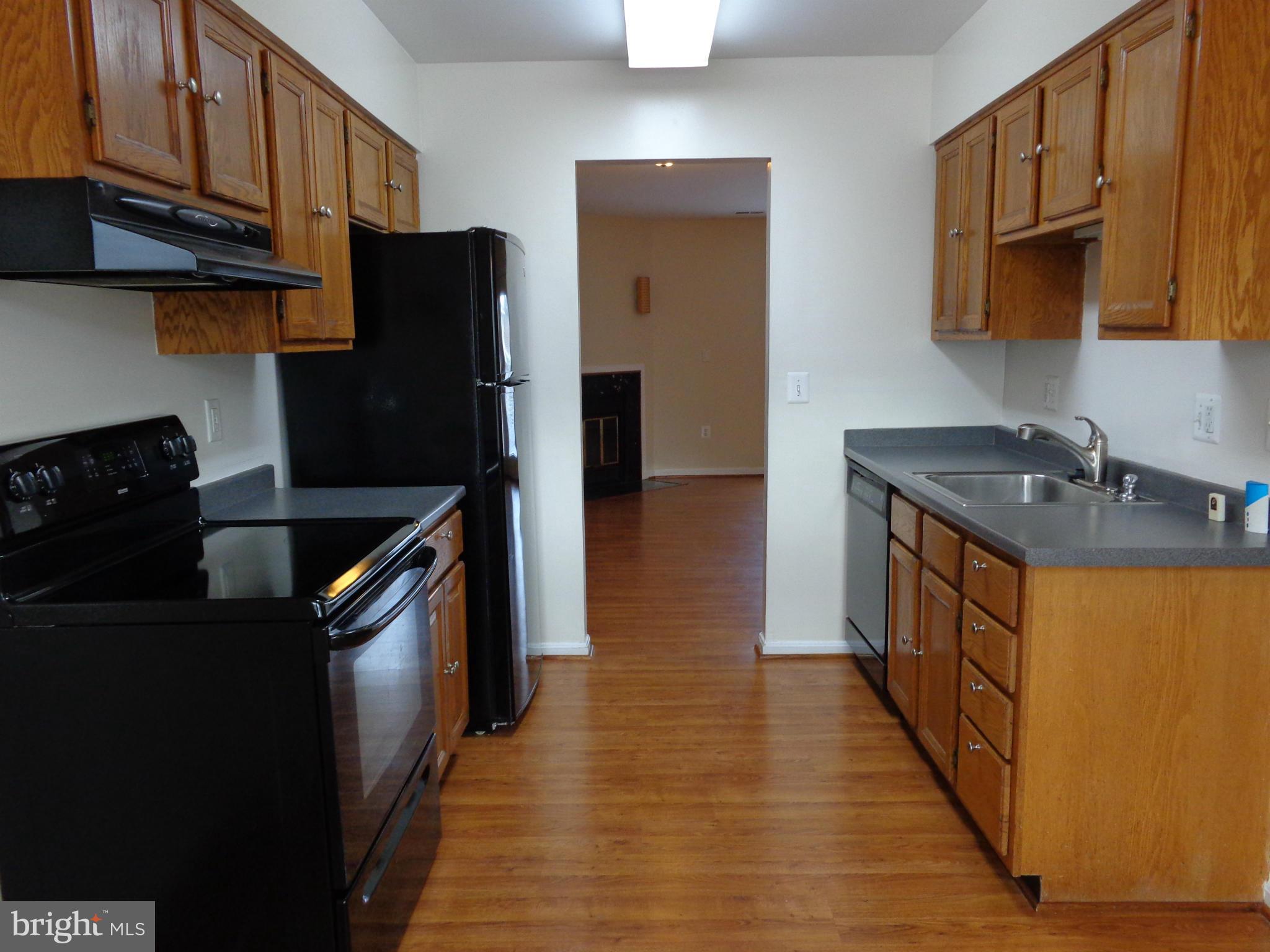7782 Gateshead Lane Manassas, VA 20109 - Photo 6 of 17 a kitchen with stainless steel appliances granite countertop a sink stove and refrigerator