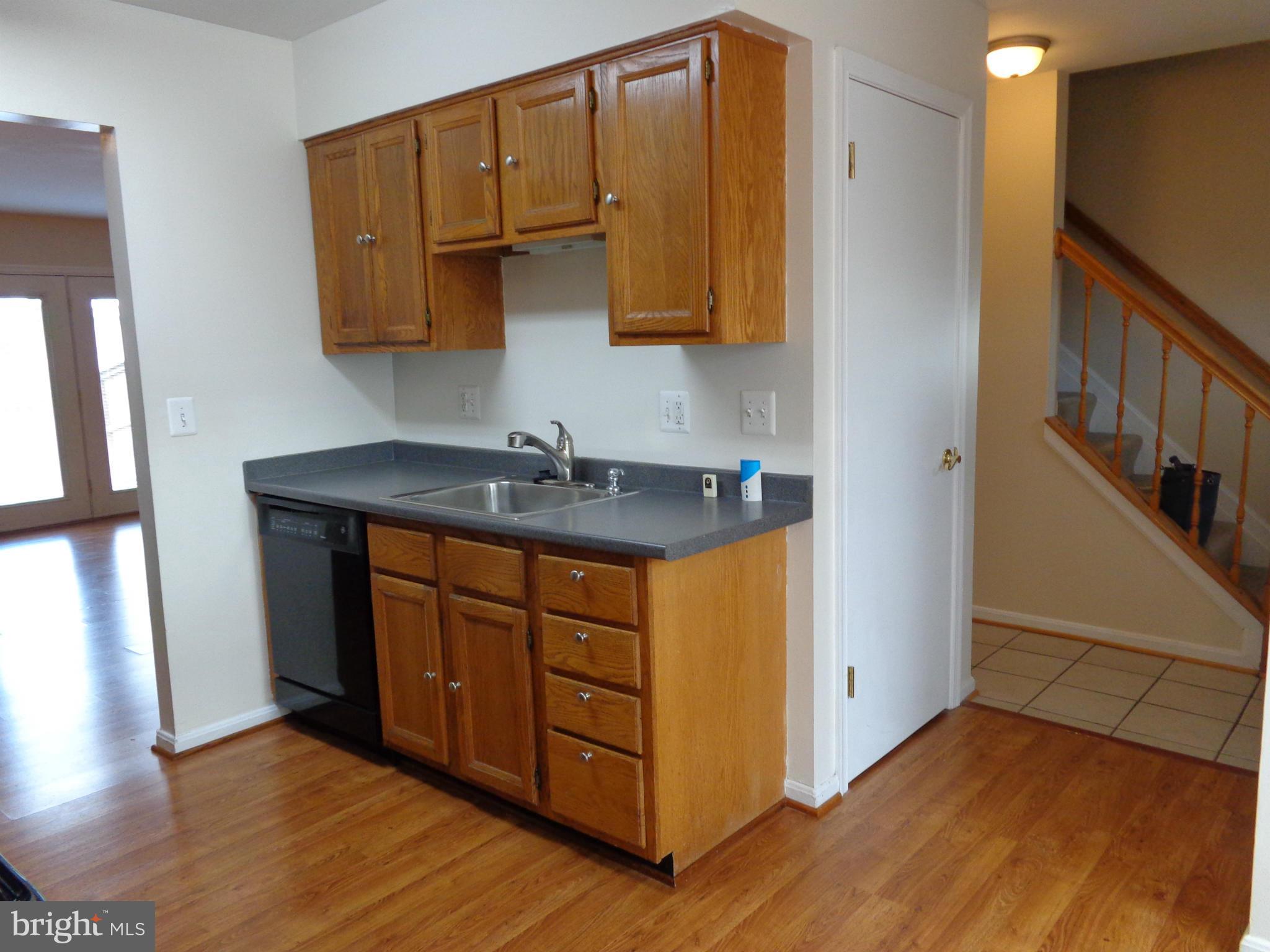 7782 Gateshead Lane Manassas, VA 20109 - Photo 7 of 17 a kitchen with stainless steel appliances granite countertop a sink a stove a refrigerator and cabinets