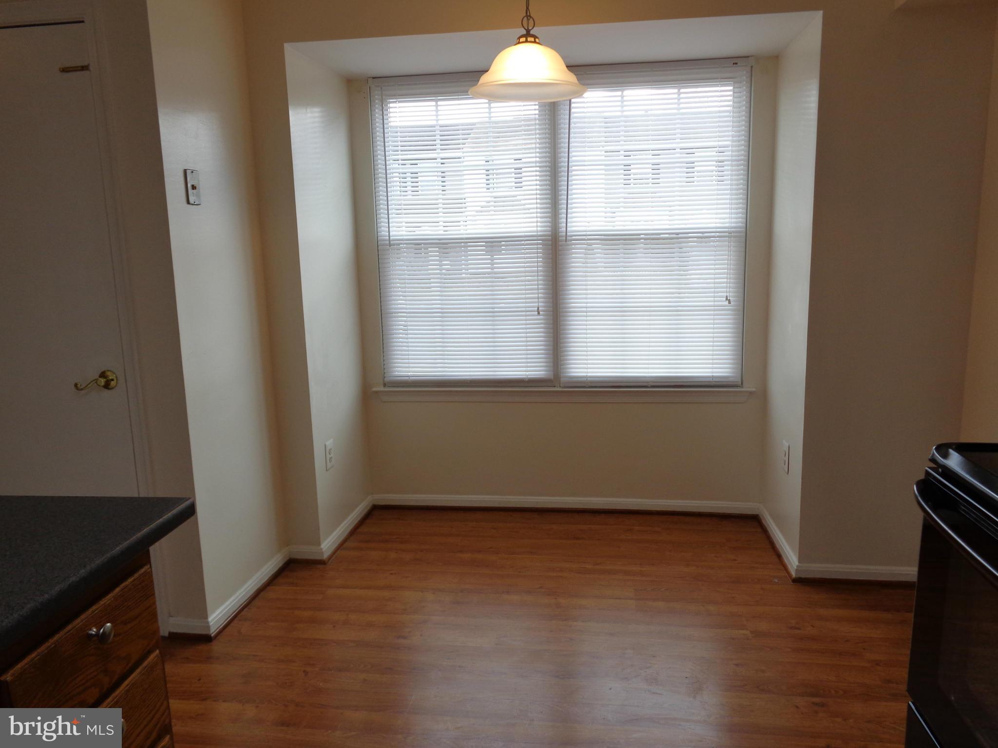 7782 Gateshead Lane Manassas, VA 20109 - Photo 8 of 17 an empty room with wooden floor and windows