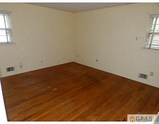 22 Lynnwood Road Edison, NJ 08820 - Photo 13 of 19 an empty room with wooden floor and windows