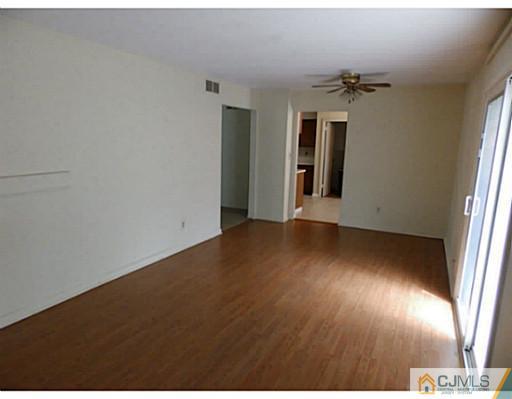 22 Lynnwood Road Edison, NJ 08820 - Photo 17 of 19 an empty room with wooden floor and windows