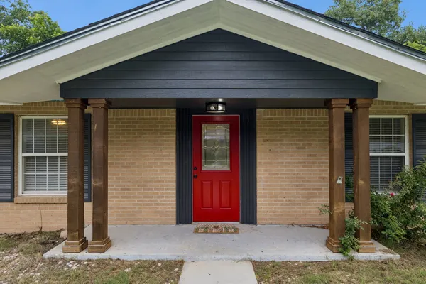 a front view of a house with red gate