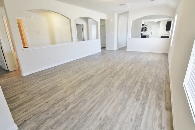 wooden floor in an empty room with a mirror