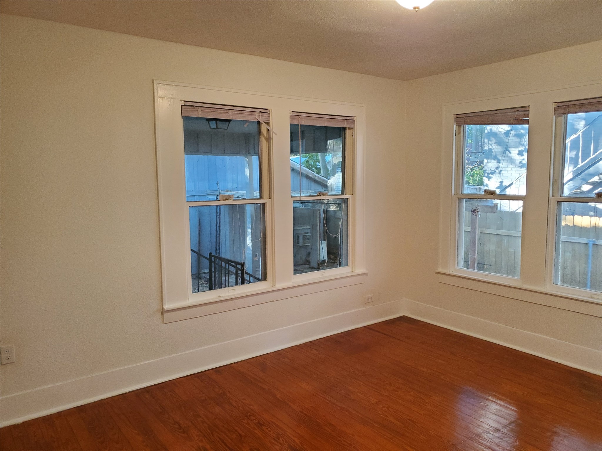 4113 Speedway Austin, TX 78751 - Photo 10 of 31 Rich hardwood flooring complements classic wood-framed windows in this inviting interior space.
