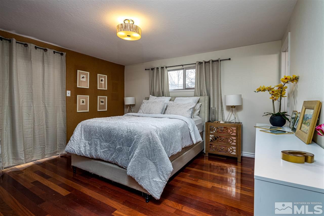 2401 Balsam Street Reno, NV 89509 - Photo 13 of 18 a bedroom with a bed and a lamp on dresser with wooden floor