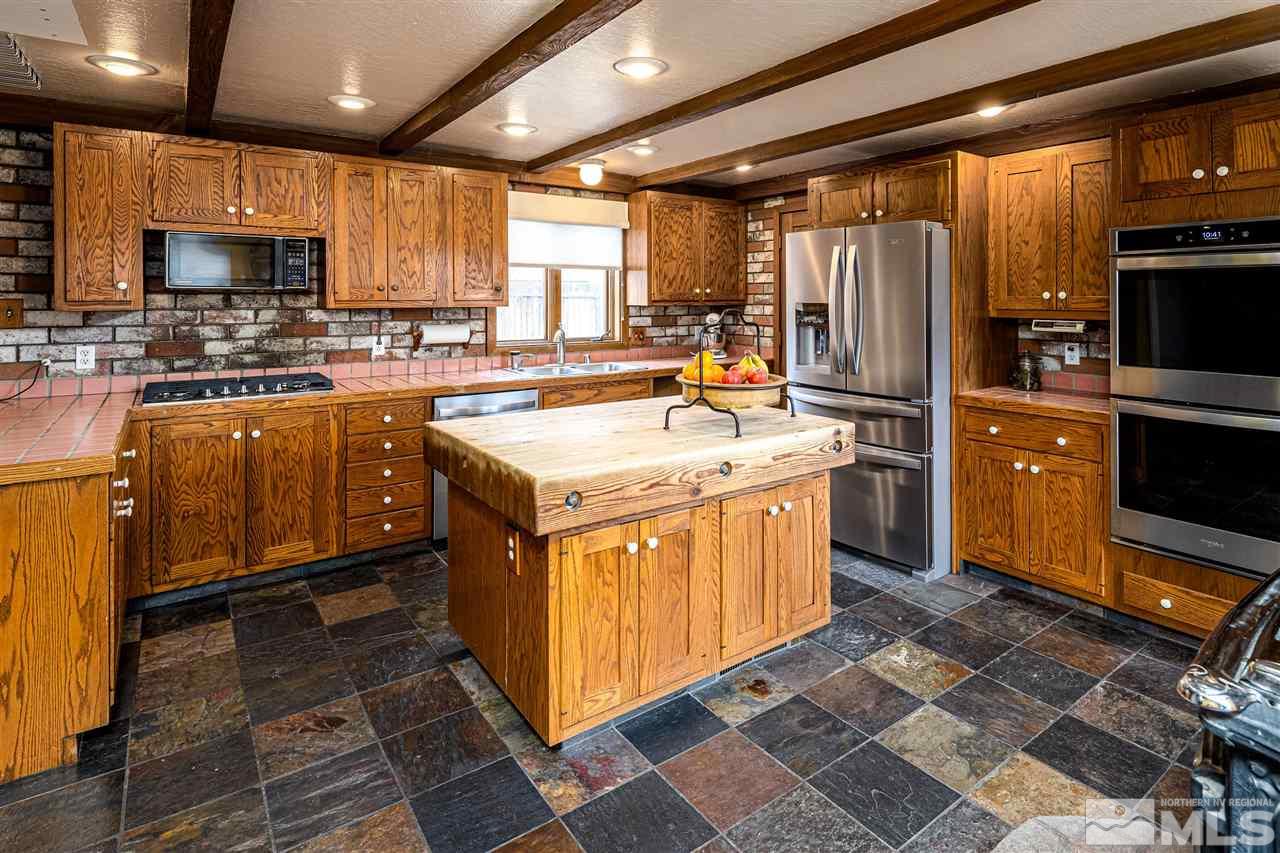 2401 Balsam Street Reno, NV 89509 - Photo 8 of 18 a kitchen with refrigerator stove microwave and cabinets