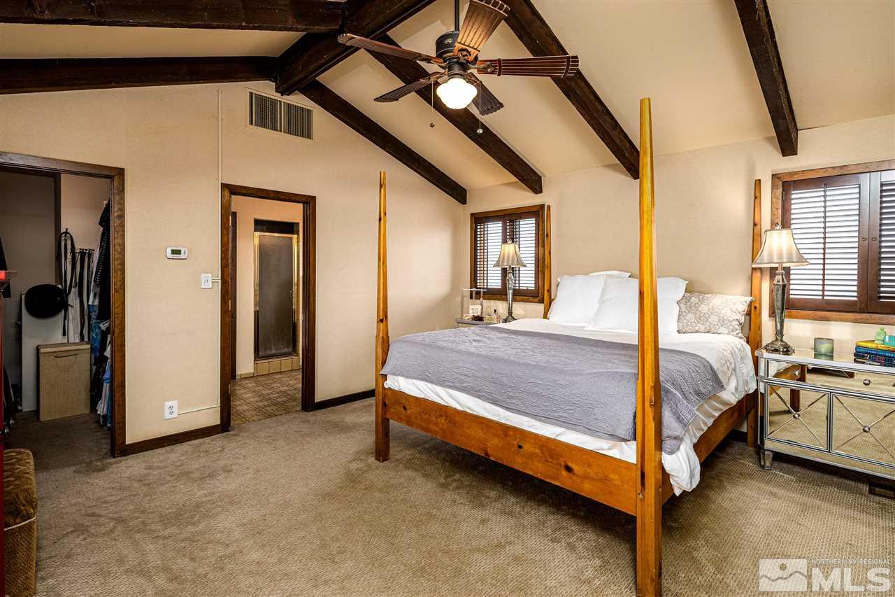 2401 Balsam Street Reno, NV 89509 - Photo 9 of 18 a bed room with a bed and a chandelier