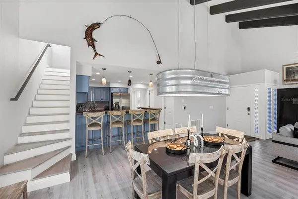 a dinning area with furniture and wooden floor