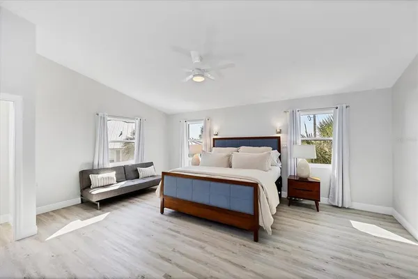 a spacious bedroom with a bed and a couch