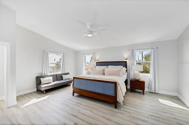 a spacious bedroom with a bed and a couch