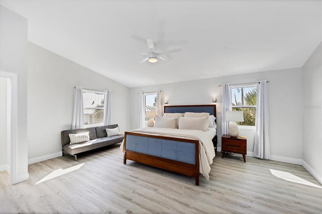 401 Lafitte Street Boca Grande, FL 33921 - Photo 19 of 37 a spacious bedroom with a bed and a couch