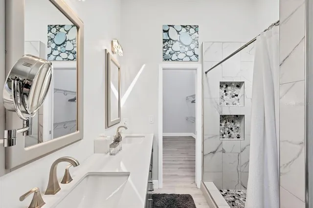 a bathroom with a shower and a sink