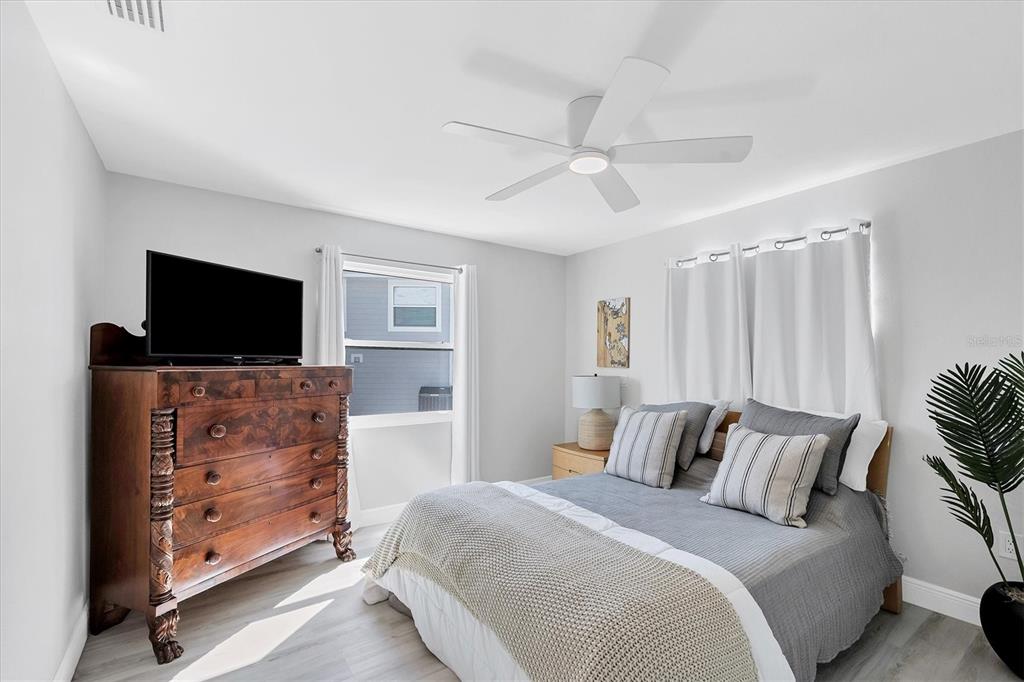 401 Lafitte Street Boca Grande, FL 33921 - Photo 22 of 37 a bedroom with a bed and a flat screen tv