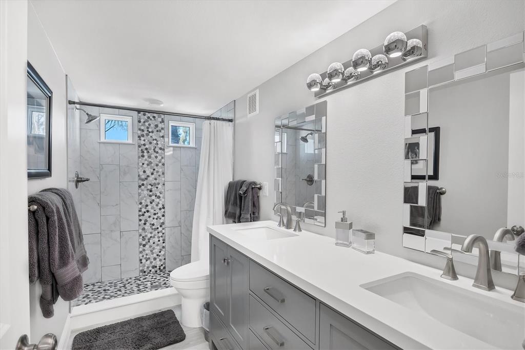 401 Lafitte Street Boca Grande, FL 33921 - Photo 24 of 37 a bathroom with a sink double vanity and a mirror