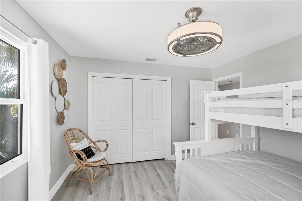 401 Lafitte Street Boca Grande, FL 33921 - Photo 26 of 37 a bedroom with a bed and a chandelier