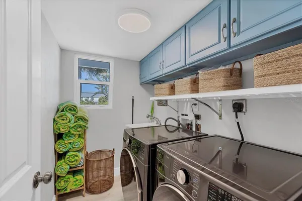 a utility room with multiple dryer and washer