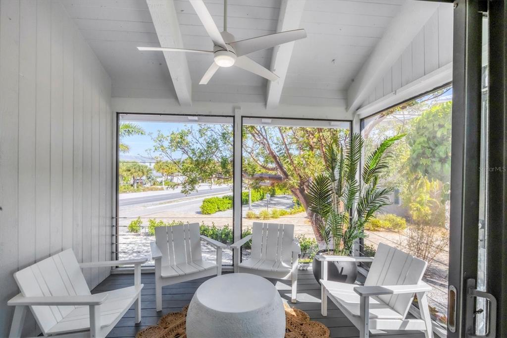 401 Lafitte Street Boca Grande, FL 33921 - Photo 28 of 37 a living room with large windows and a table