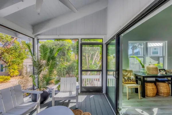 a living room with furniture and floor to ceiling windows