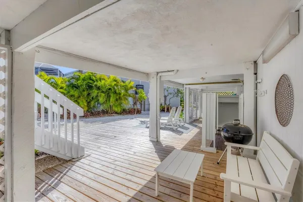 a view of a porch with wooden floor and outdoor space