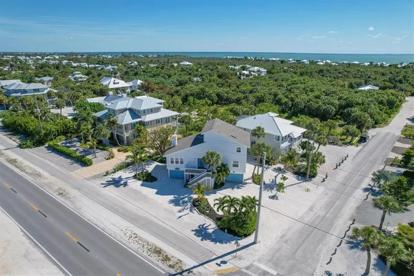 an aerial view of residential houses with outdoor space and street view