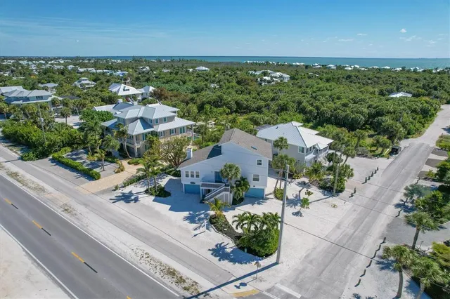 an aerial view of residential houses with outdoor space and street view