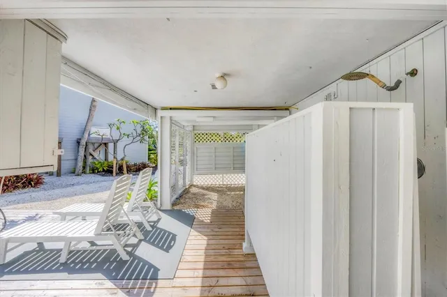a view of a hallway with wooden floor and windows