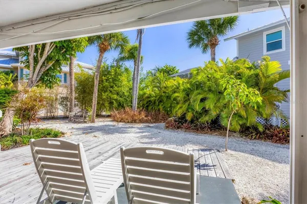 a view of a backyard with plants and a patio