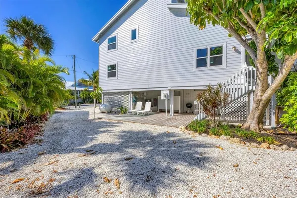 a view of a house with a yard and tree s