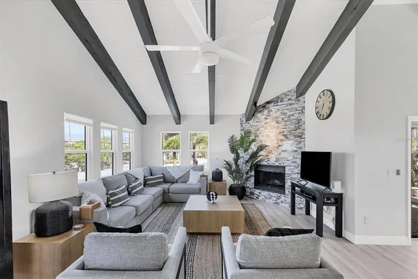 a living room with furniture a fireplace and a flat screen tv