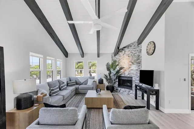 a living room with furniture a fireplace and a flat screen tv