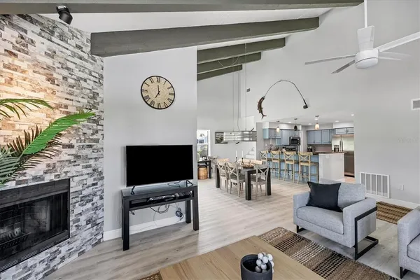 a living room with furniture a rug and a fireplace